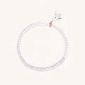 Double-wrap lavender beaded bracelet with rose quartz, pearls, gold vermeil charm and pink tassel on white background.