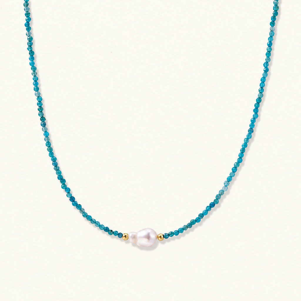 Dainty teal apatite beaded necklace with a single freshwater pearl centerpiece flanked by two small gold beads, adjustable gold clasp.