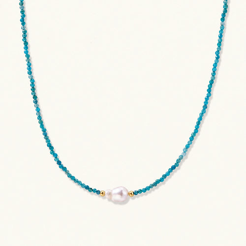 Dainty teal apatite beaded necklace with a single freshwater pearl centerpiece flanked by two small gold beads, adjustable gold clasp.