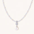 Dainty necklace with lavender crystal beads, freshwater pearls, geometric pendant, and large pearl drop on white background.