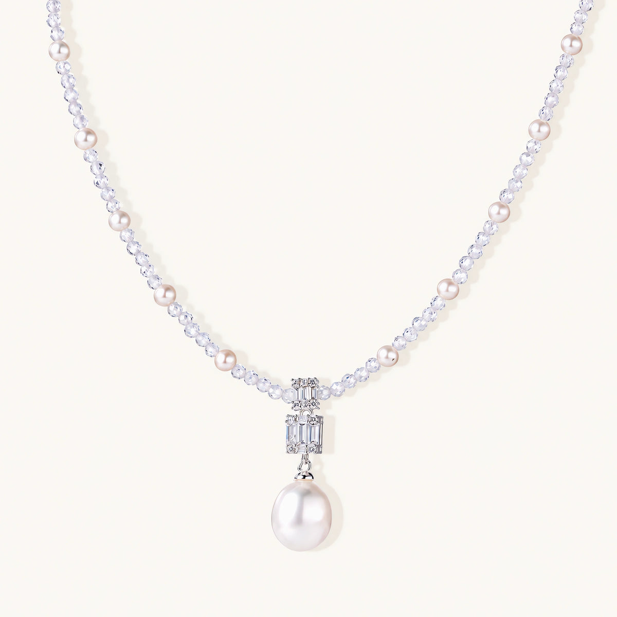 Dainty necklace with lavender crystal beads, freshwater pearls, geometric pendant, and large pearl drop on white background.