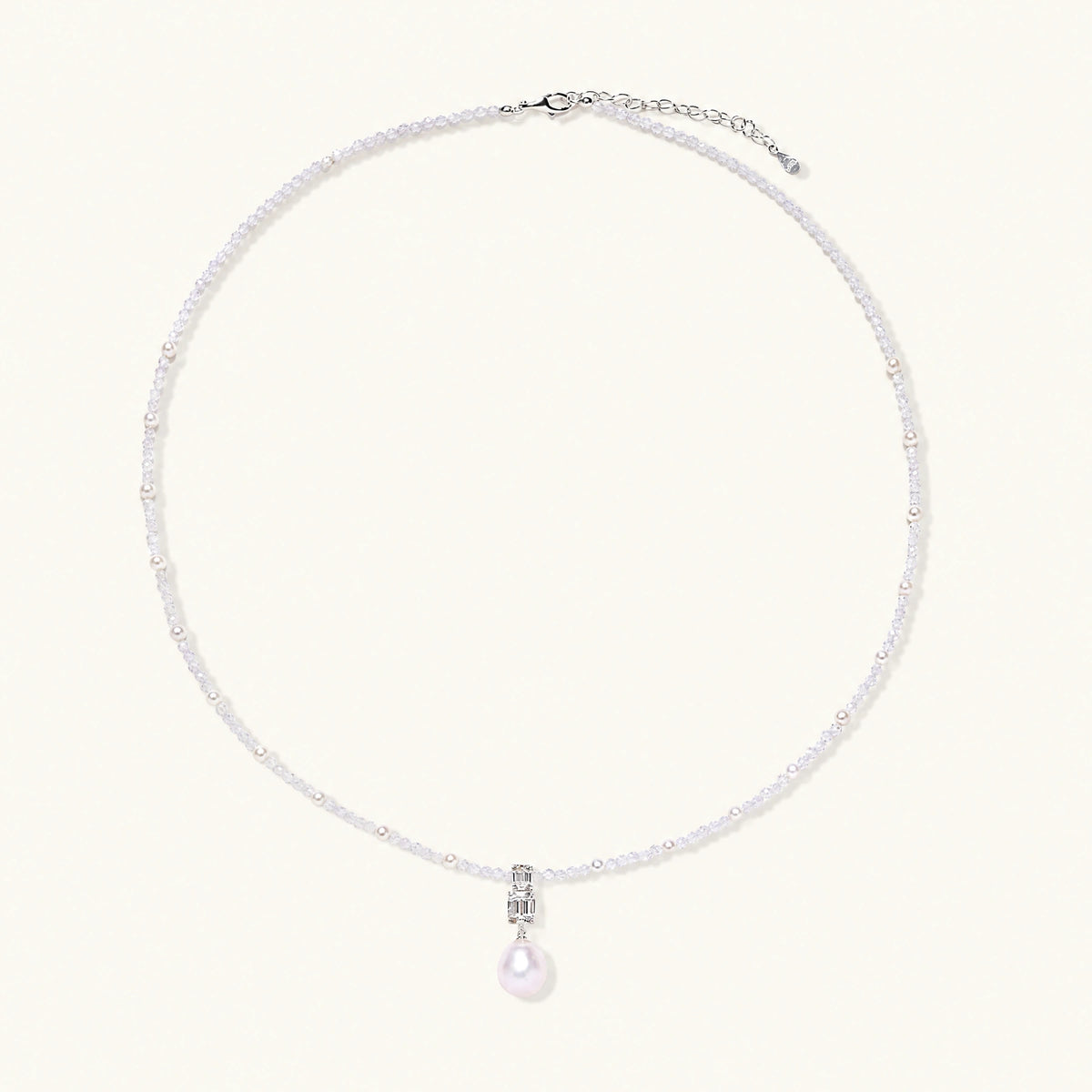 Dainty necklace with lavender crystal beads, freshwater pearls, geometric pendant, and large pearl drop on white background.