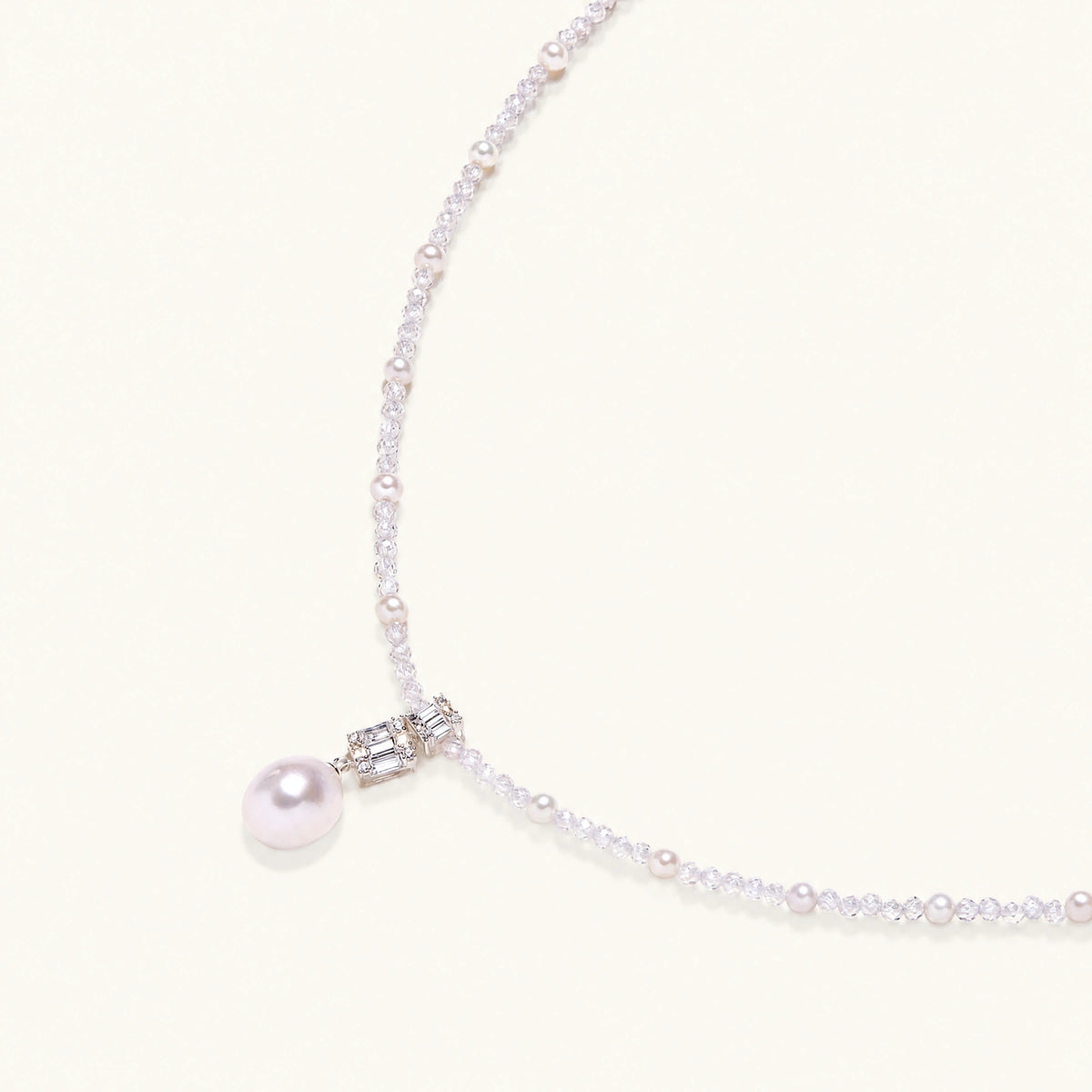 Dainty necklace with lavender crystal beads, freshwater pearls, geometric pendant, and large pearl drop on white background.