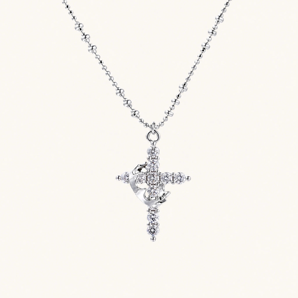 White gold-plated cross pendant adorned with sparkling zirconia stones and crescent moon accent on ball chain