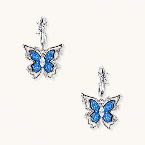 Silver hoop earrings with blue denim butterfly charms outlined in barbed wire design and central zirconia stone