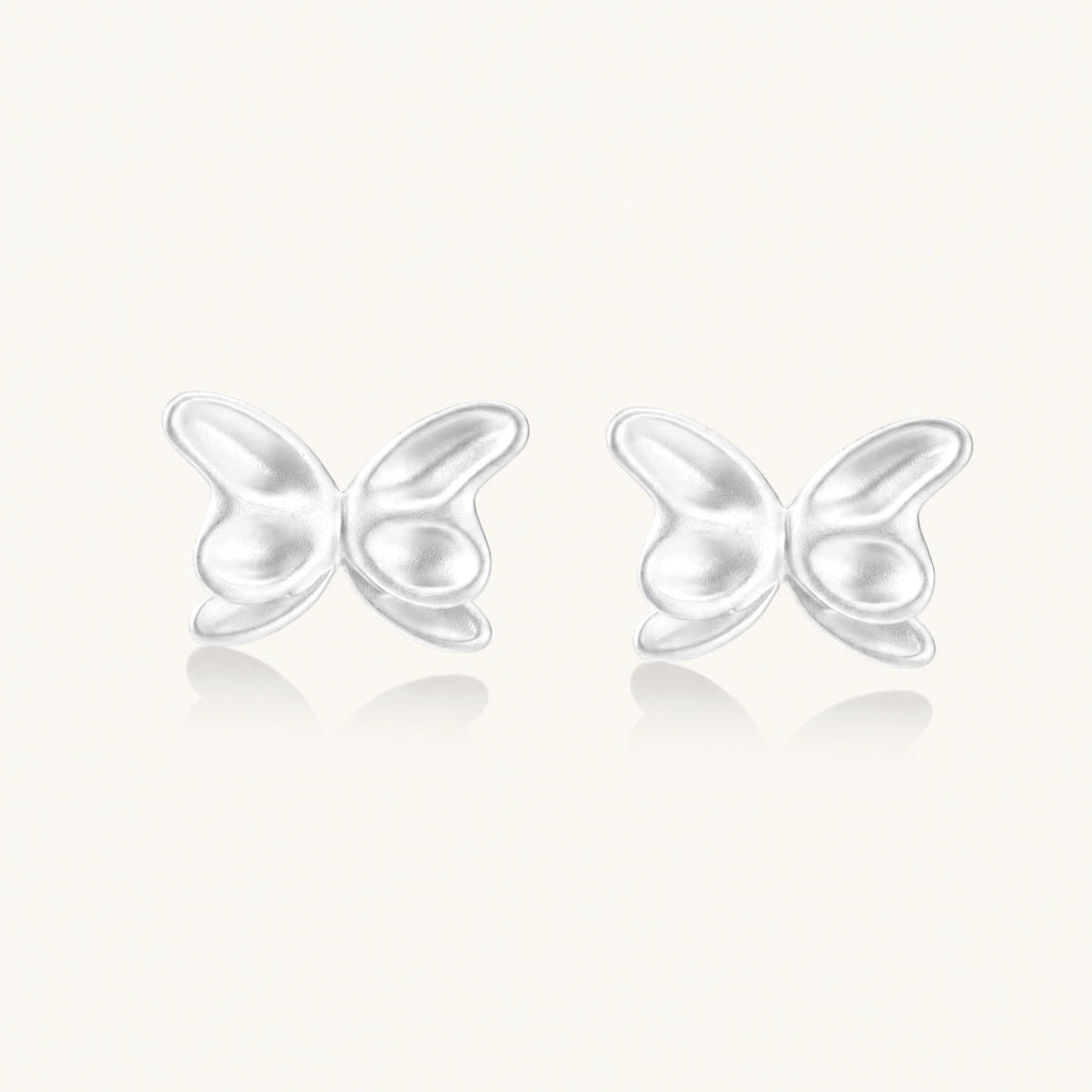 Pair of translucent butterfly-shaped stud earrings with frosted finish and dimensional wing details on white background
