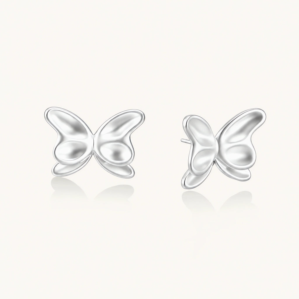 Pair of translucent butterfly-shaped stud earrings with frosted finish and dimensional wing details on white background