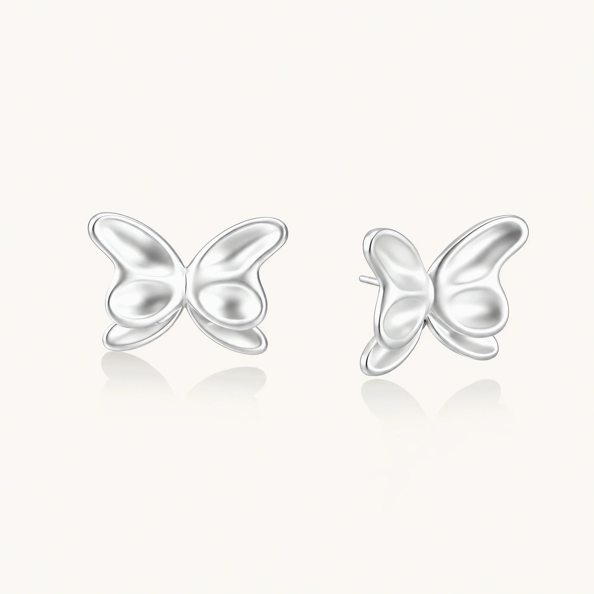 Pair of translucent butterfly-shaped stud earrings with frosted finish and dimensional wing details on white background