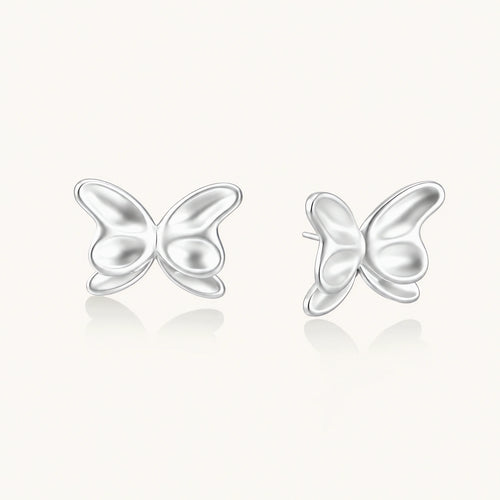 Pair of translucent butterfly-shaped stud earrings with frosted finish and dimensional wing details on white background