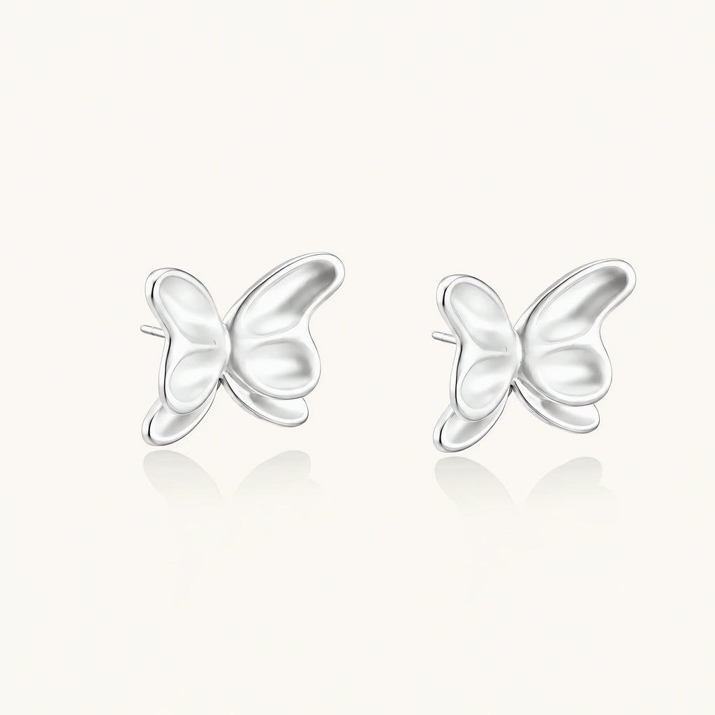 Pair of translucent butterfly-shaped stud earrings with frosted finish and dimensional wing details on white background