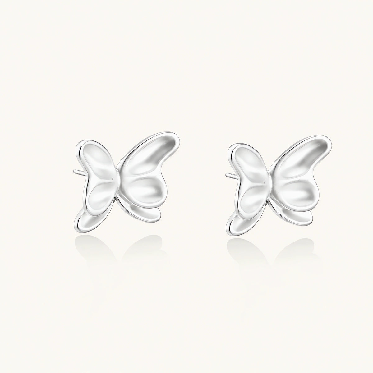 Pair of translucent butterfly-shaped stud earrings with frosted finish and dimensional wing details on white background