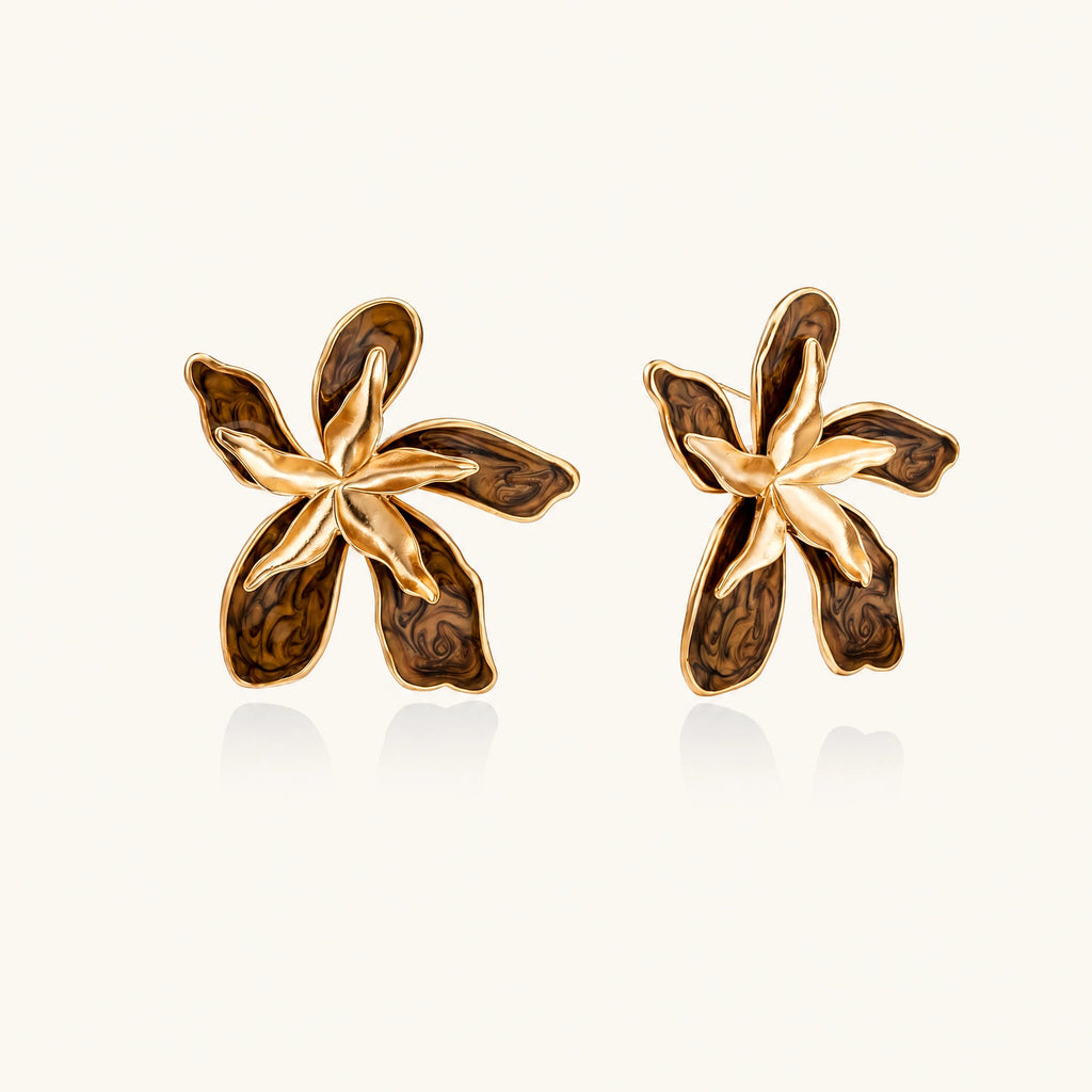Gold-plated brass flower earrings with brown tortoiseshell enamel petals on cream background