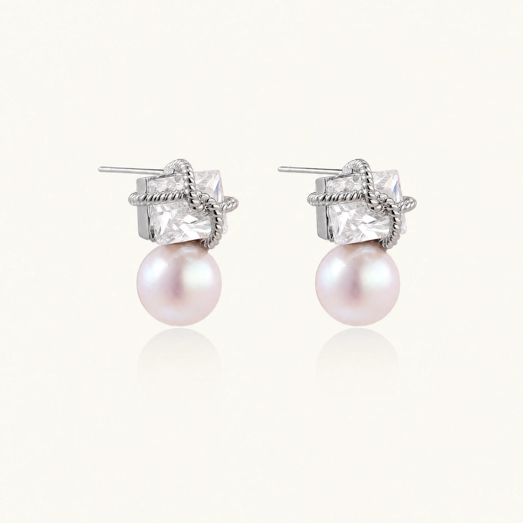 White gold stud earrings with square crystal stones in twisted frames and pink freshwater pearl drops below