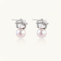 White gold stud earrings with square crystal stones in twisted frames and pink freshwater pearl drops below