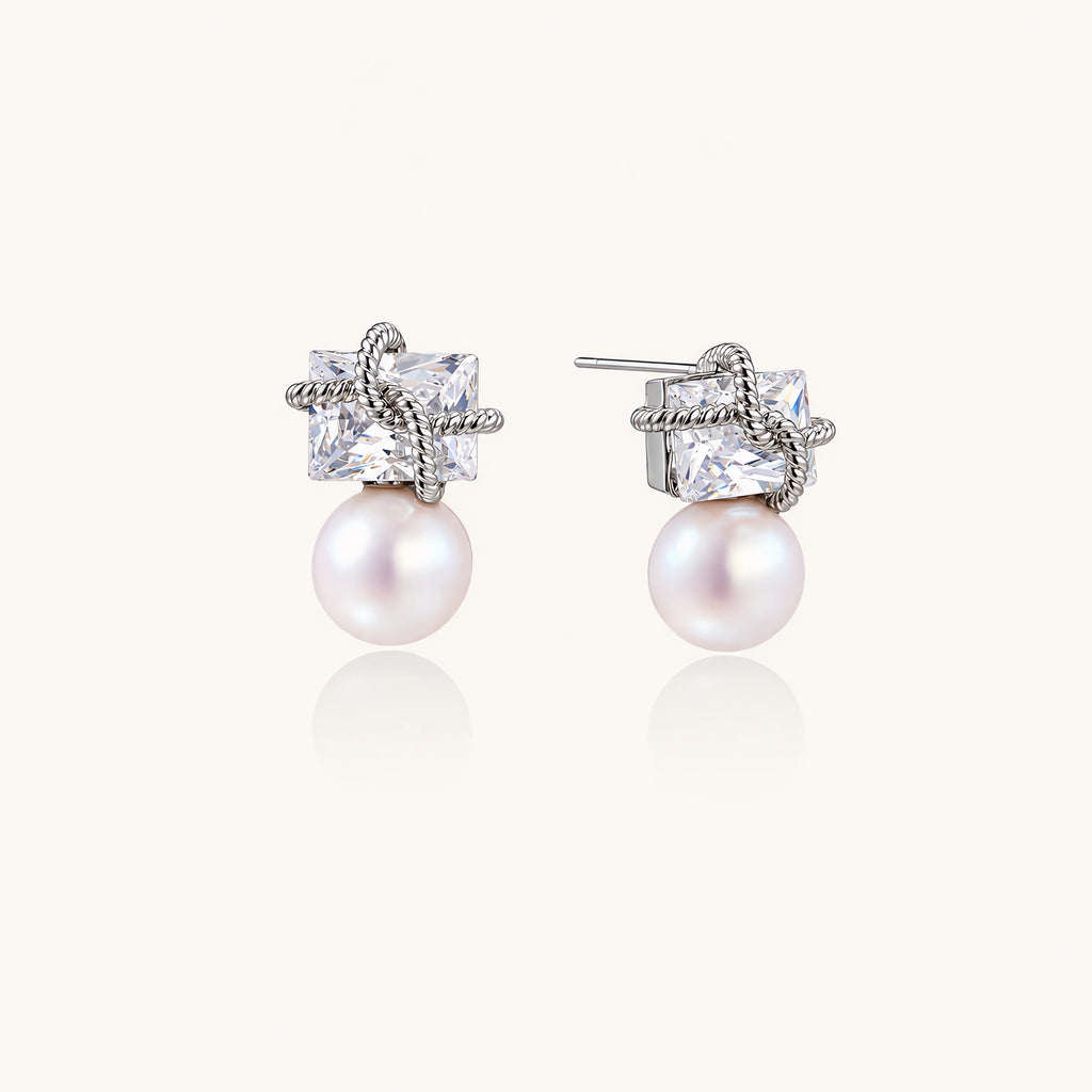 White gold stud earrings with square crystal stones in twisted frames and pink freshwater pearl drops below