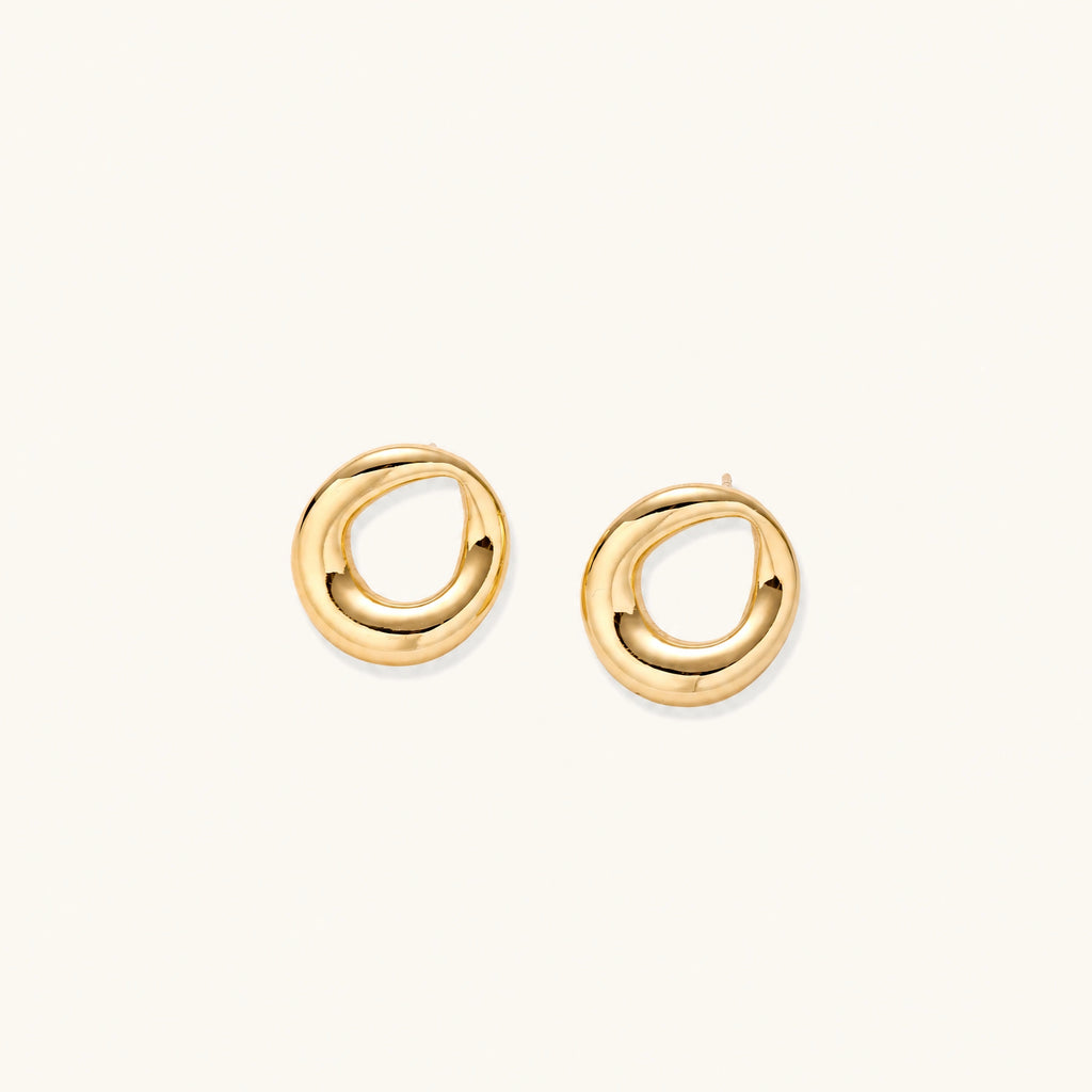 Pair of polished 18K gold-plated stainless steel teardrop earrings with hollow centers on cream background