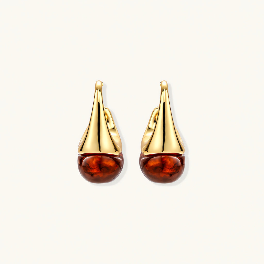 Modern drop earrings with curved gold-plated copper tops and amber resin bottoms creating an organic teardrop silhouette.