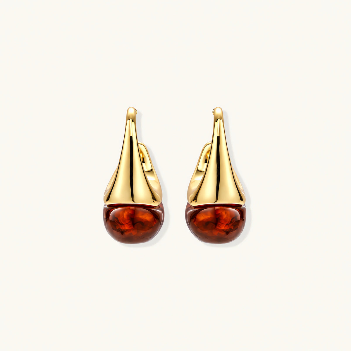 Modern drop earrings with curved gold-plated copper tops and amber resin bottoms creating an organic teardrop silhouette.