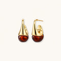 Modern drop earrings with curved gold-plated copper tops and amber resin bottoms creating an organic teardrop silhouette.