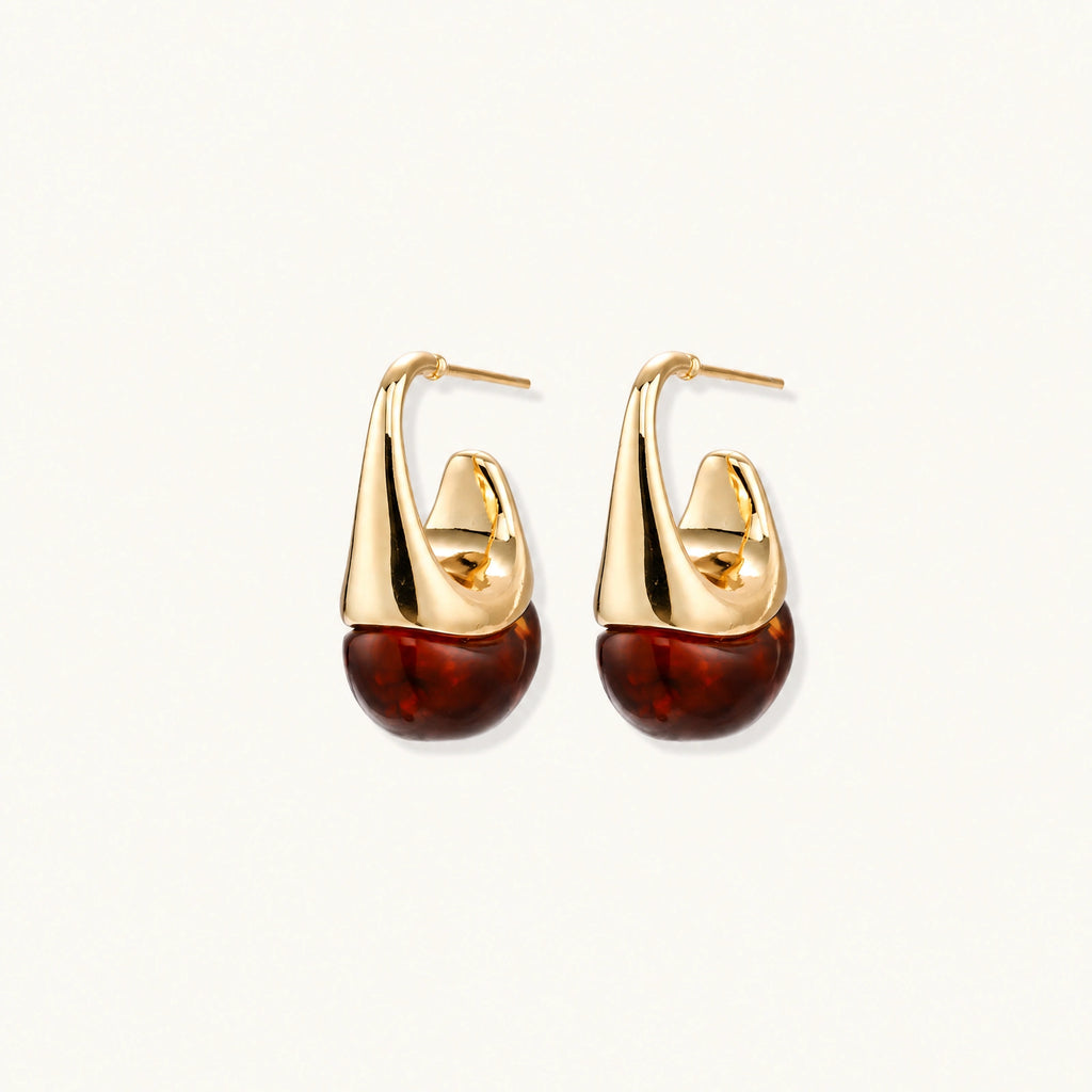 Modern drop earrings with curved gold-plated copper tops and amber resin bottoms creating an organic teardrop silhouette.