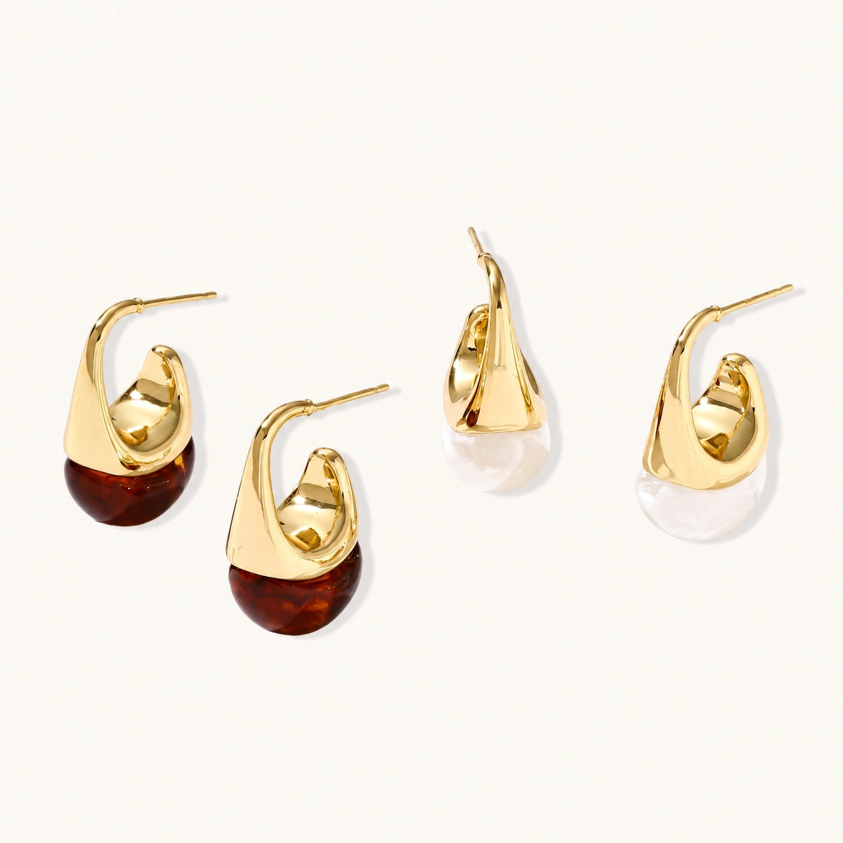 Modern drop earrings with curved gold-plated copper tops and amber resin bottoms creating an organic teardrop silhouette.