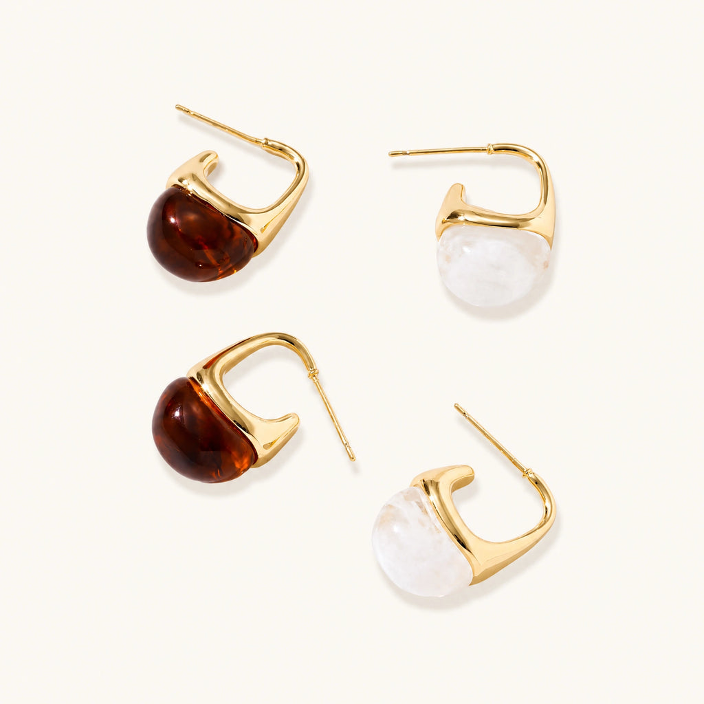 Modern drop earrings with curved gold-plated copper tops and amber resin bottoms creating an organic teardrop silhouette.