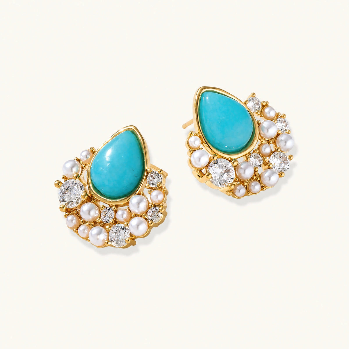 Gold-plated cluster earrings with teardrop turquoise stones surrounded by white pearls and clear crystals