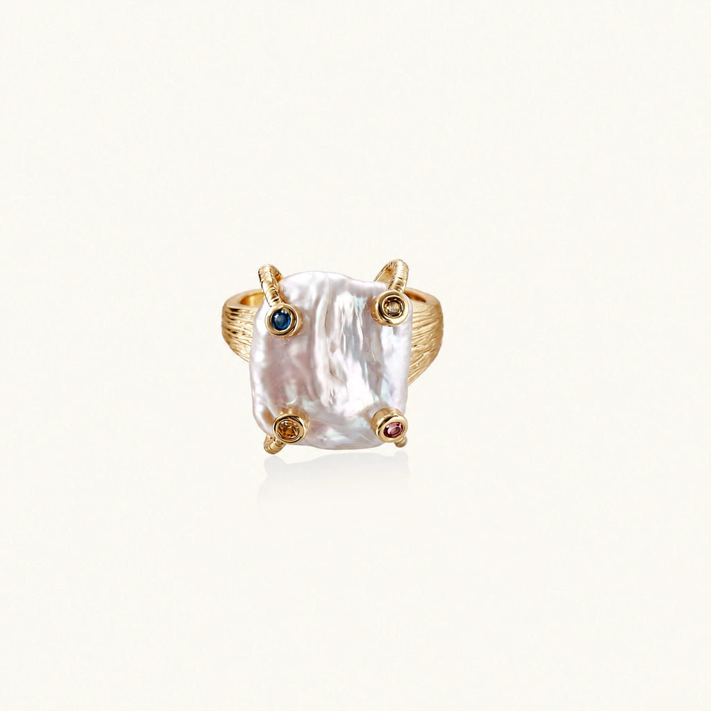 Gold ring with large iridescent baroque pearl and four colored gemstones on textured band