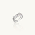 Silver-toned adjustable crown ring with channel-set square zirconia stones and delicate floral details on white background